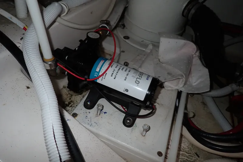 Slide: The Image of Engine compartment of a 2005 Bertram 390 with a Shurflo pump and wiring. - 139
