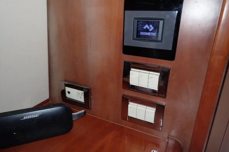 Slide: The Image of Control panel and switches on a 2005 Bertram 390 yacht interior. - 76