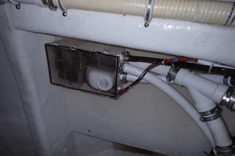 Slide: The Image of Engine compartment wiring and hoses in a 2005 Bertram 390 boat. - 105