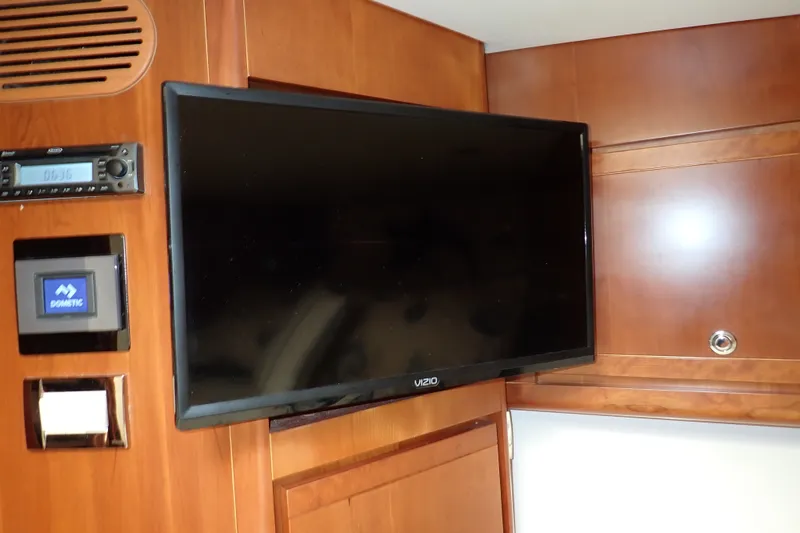 Slide: The Image of Flat-screen TV and control panel in 2005 Bertram 390 yacht interior. - 85