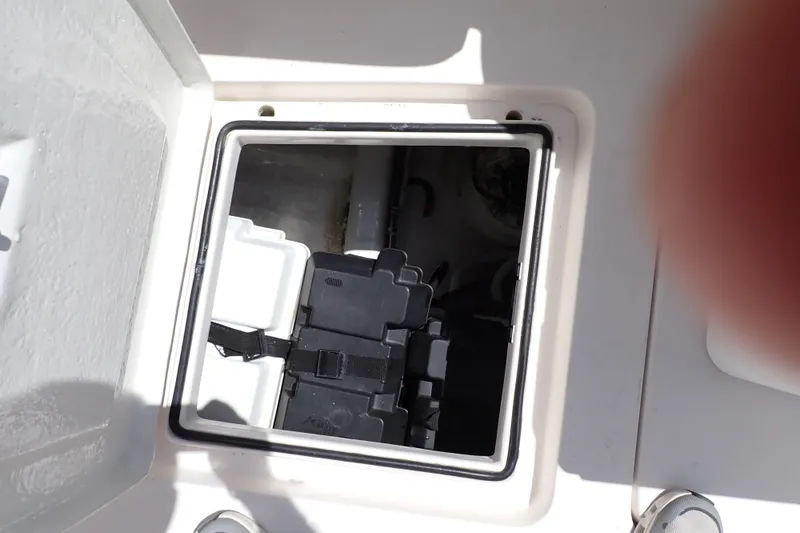 Slide: The Image of Open hatch on 2005 Bertram 390 boat, revealing interior compartment and equipment. - 111