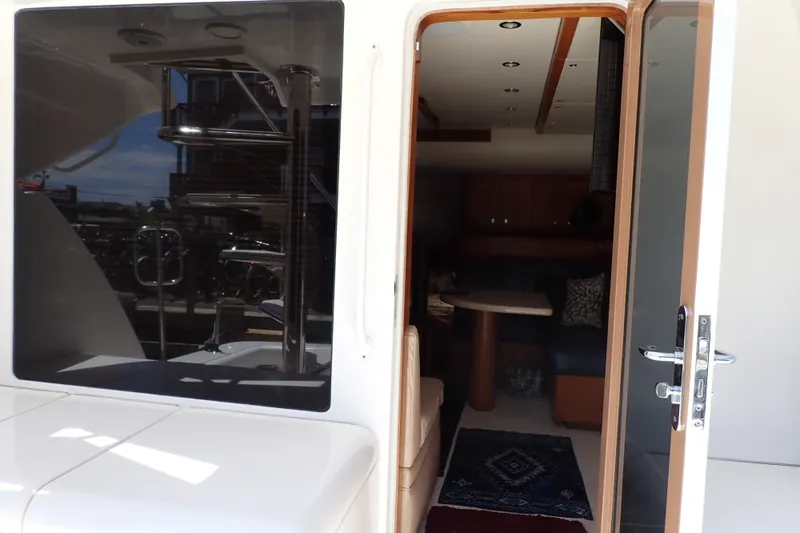 Slide: The Image of Interior view of a 2005 Bertram 390 yacht, showcasing the cabin entrance. - 9
