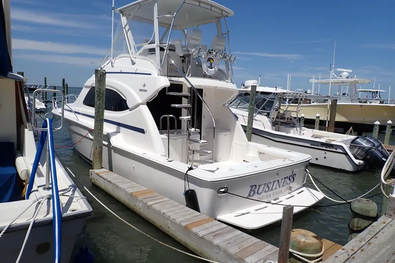 Slide: The Image of 2005 Bertram 390 yacht docked at marina under clear blue sky. - 6
