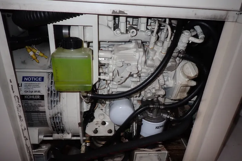 Slide: The Image of Engine compartment of a 2005 Bertram 390 with Kohler generator and green coolant container. - 145