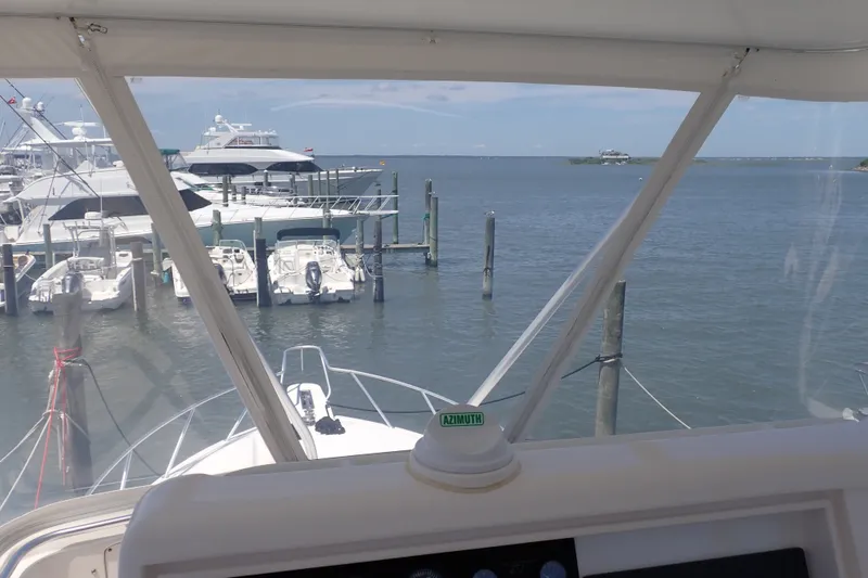 Slide: The Image of View from a 2005 Bertram 390 yacht cockpit overlooking a marina with boats. - 33