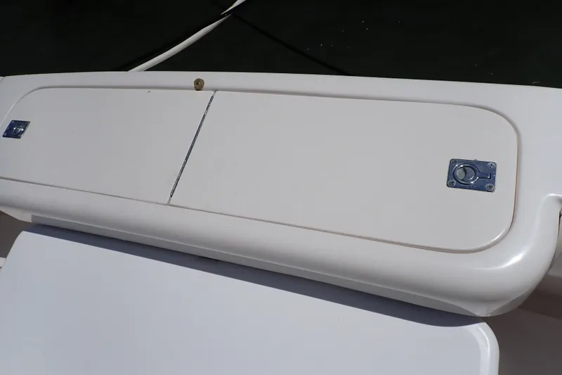 Slide: The Image of 2005 Bertram 390 boat storage compartment with secure latch and sleek design. - 114