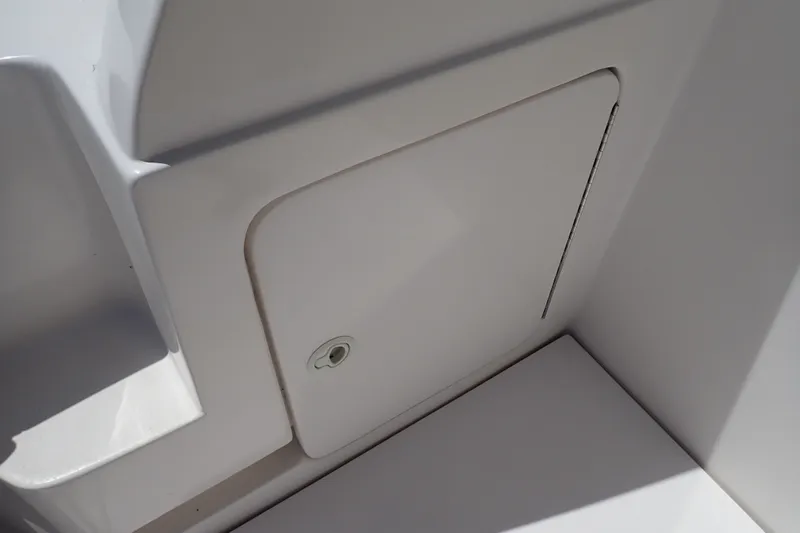 Slide: The Image of Storage compartment on a 2005 Bertram 390 boat, featuring a sleek white design. - 117