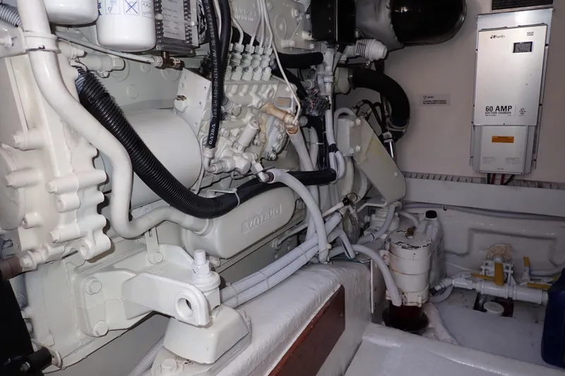 Slide: The Image of Engine room of a 2005 Bertram 390 boat, featuring Volvo components and electrical systems. - 130