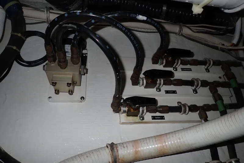 Slide: The Image of Electrical wiring and connectors in a 2005 Bertram 390 boat engine room. - 136
