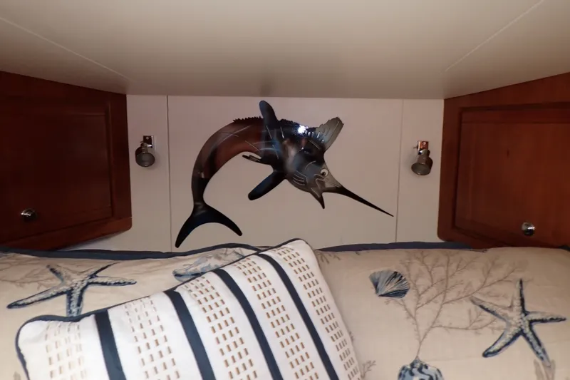 Slide: The Image of Cozy cabin interior of 2005 Bertram 390 with nautical decor and marlin wall art. - 84