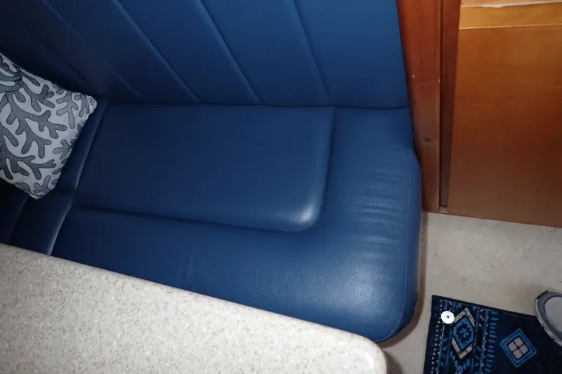Slide: The Image of Blue leather seating in 2005 Bertram 390 yacht interior with decorative pillow. - 72