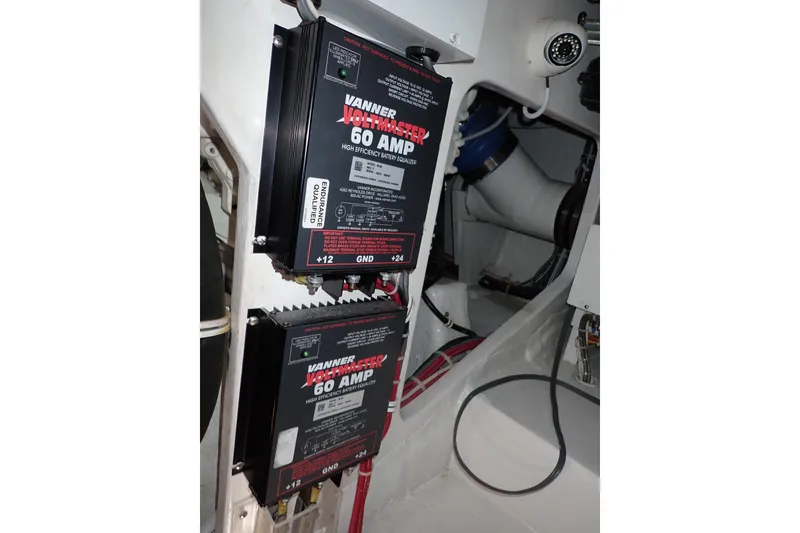 Slide: The Image of Electrical components in a 2005 Bertram 390 boat engine room, featuring Vanner Voltmaster 60 Amp units. - 141