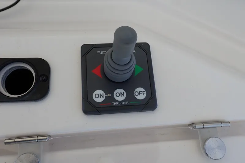 Slide: The Image of Joystick control panel on a 2005 Bertram 390 boat, featuring thruster controls. - 44