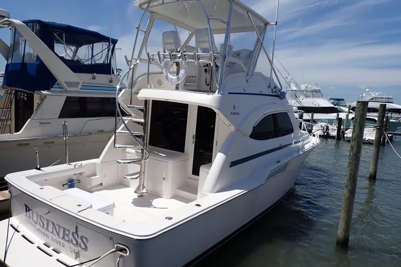 Slide: The Image of 2005 Bertram 390 yacht docked at marina under clear blue sky. - 1