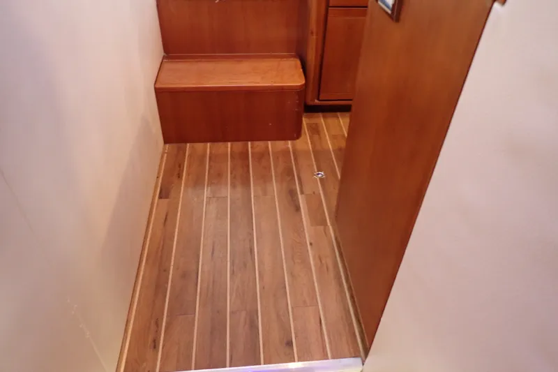 Slide: The Image of Interior of 2005 Bertram 390 yacht featuring wooden flooring and steps. - 51