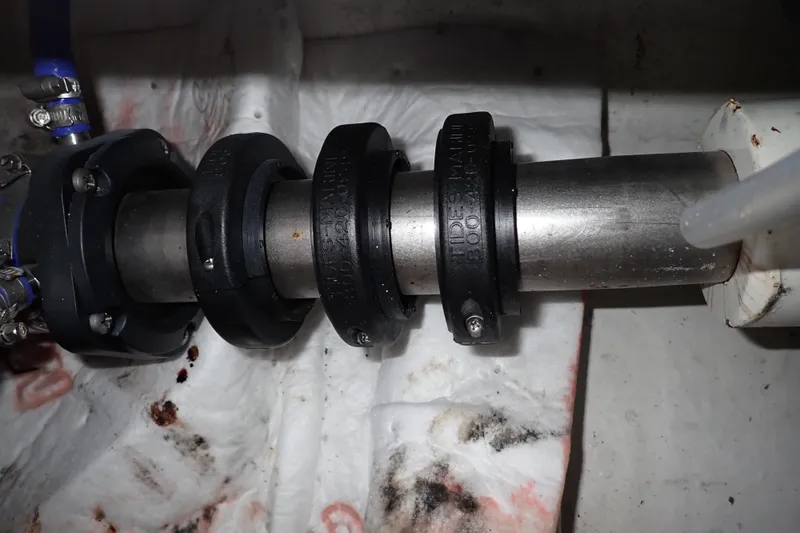 Slide: The Image of Close-up of a 2005 Bertram 390 boat shaft with clamps and seals. - 127