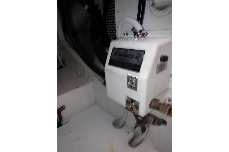 Slide: The Image of Engine compartment of a 2005 Bertram 390 boat showing an oil exchange system. - 132