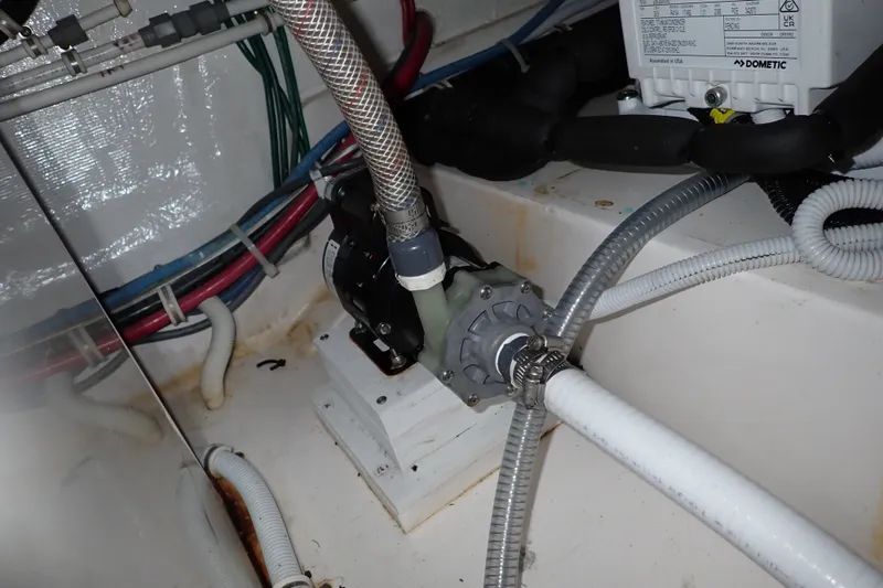 Slide: The Image of Engine room of 2005 Bertram 390 boat with visible wiring and plumbing components. - 143