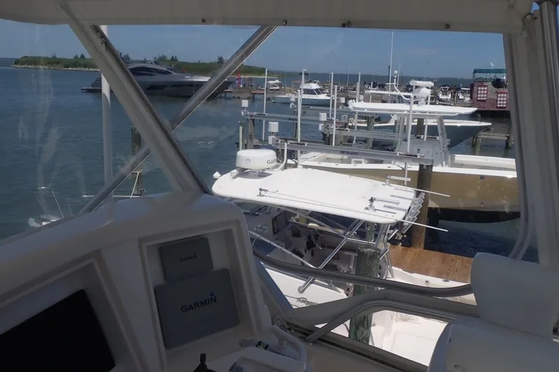 Slide: The Image of Bertram 390 yacht docked at marina, view from cockpit, Garmin equipment visible, 2005 model. - 34