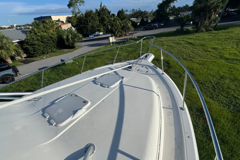 Slide: The Image of 2006 Pro-Line 35 Express boat deck with hatches, surrounded by greenery and trees. - 35