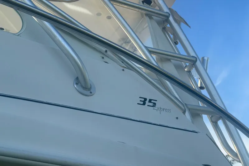 Slide: The Image of 2006 Pro-Line 35 Express boat with metal railings against a clear blue sky. - 29