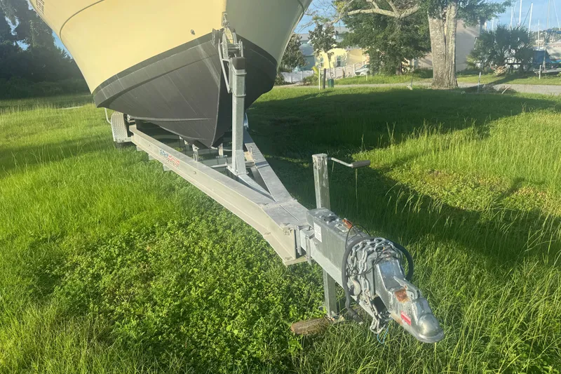 Slide: The Image of 2006 Pro-Line 35 Express boat on trailer in grassy area, sunny day. - 26