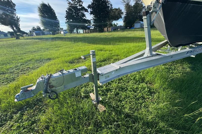 Slide: The Image of Trailer hitch of a 2006 Pro-Line 35 Express boat on grassy field. - 27