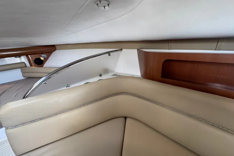 Slide: The Image of Interior of 2006 Pro-Line 35 Express boat with beige seating and wood accents. - 15