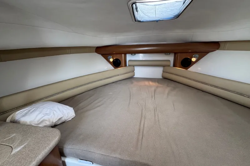 Slide: The Image of 2006 Pro-Line 35 Express cabin interior with bed, pillow, and overhead hatch. - 16