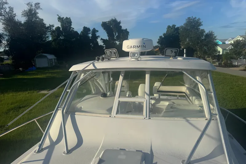 Slide: The Image of 2006 Pro-Line 35 Express boat with Garmin equipment, docked on grassy area. - 32
