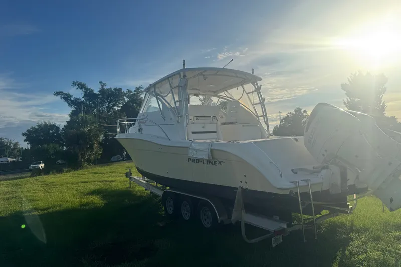 Slide: The Image of 2006 Pro-Line 35 Express boat on trailer in sunny outdoor setting. - 30