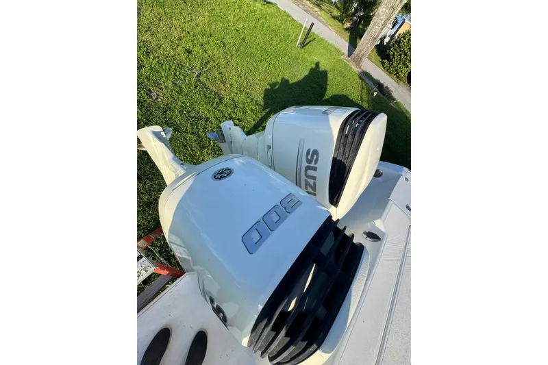 Slide: The Image of Twin Suzuki outboard motors on a 2006 Pro-Line 35 Express boat, viewed from above. - 19
