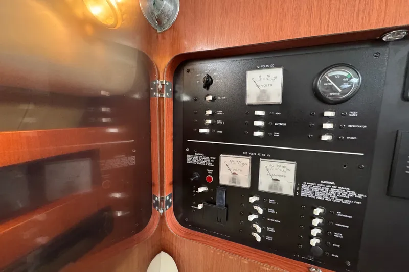 Slide: The Image of Electrical panel of a 2006 Pro-Line 35 Express boat with gauges and switches. - 14