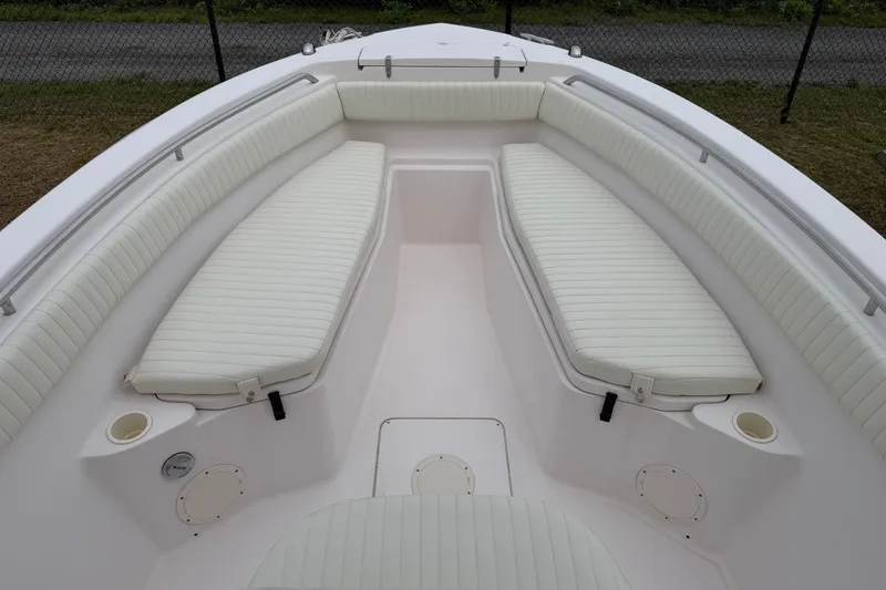 Slide: The Image of 2002 Grady White 273 Chase boat interior with white cushioned seating. - 9