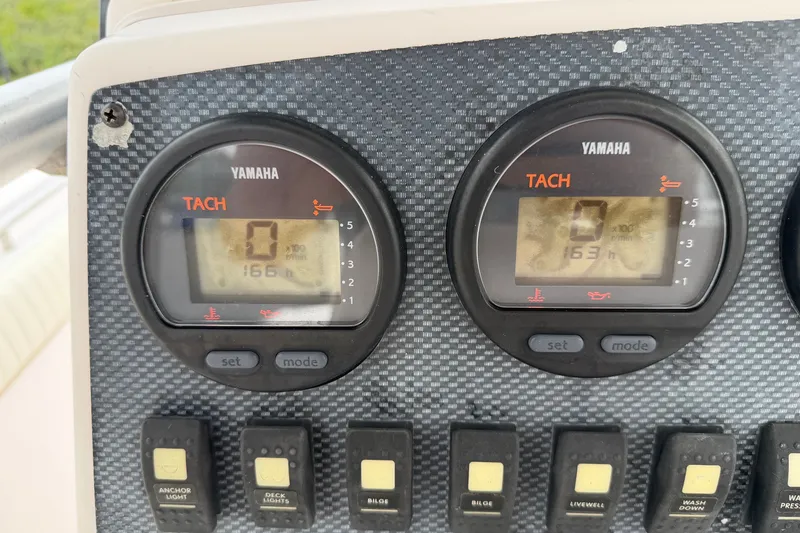 Slide: The Image of Yamaha tachometers on 2002 Grady White 273 Chase boat dashboard, displaying engine hours. - 11