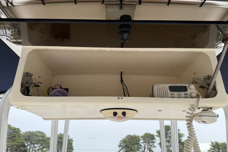 Slide: The Image of Open storage compartment on 2002 Grady White 273 Chase boat with radio equipment. - 10