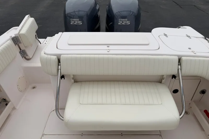 Slide: The Image of 2002 Grady White 273 Chase boat interior with Yamaha 225 engines, featuring white seating. - 19