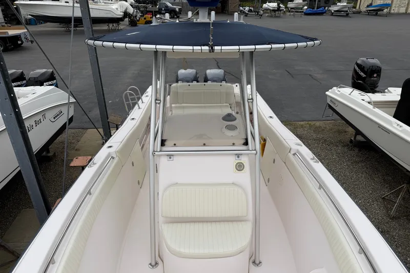 Slide: The Image of 2002 Grady White 273 Chase boat with T-top and spacious deck in marina setting. - 8