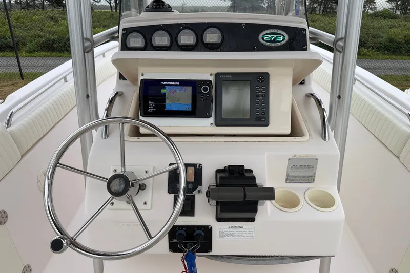 Slide: The Image of Center console of a 2002 Grady White 273 Chase boat with navigation equipment. - 13