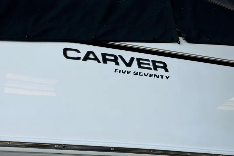 Slide: The Image of 2002 Carver 570 Voyager Pilothouse boat nameplate, featuring bold lettering. - 20