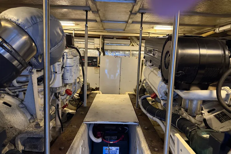 Slide: The Image of Engine room of a 2002 Carver 570 Voyager Pilothouse with visible machinery and components. - 19
