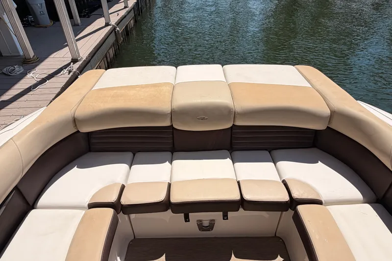 Slide: The Image of 2017 Regal 2700 ES Bowrider boat with beige and white seating at dock. - 11