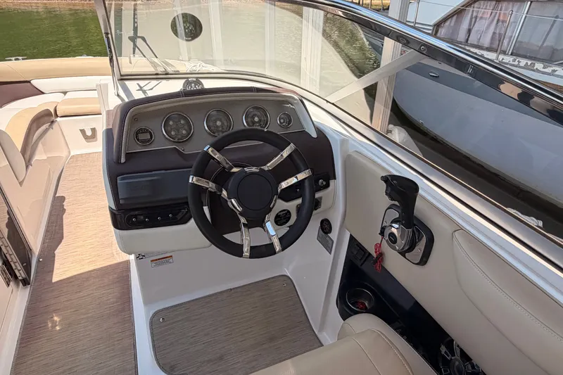 Slide: The Image of 2017 Regal 2700 ES Bowrider cockpit with steering wheel and control panel. - 9