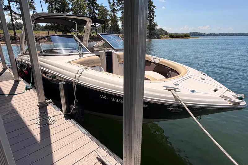 Slide: The Image of 2017 Regal 2700 ES Bowrider docked on a sunny lake. - 1