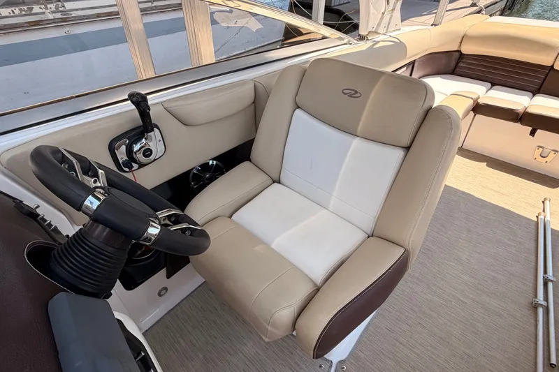 Slide: The Image of 2017 Regal 2700 ES Bowrider interior with steering wheel and beige seating. - 13