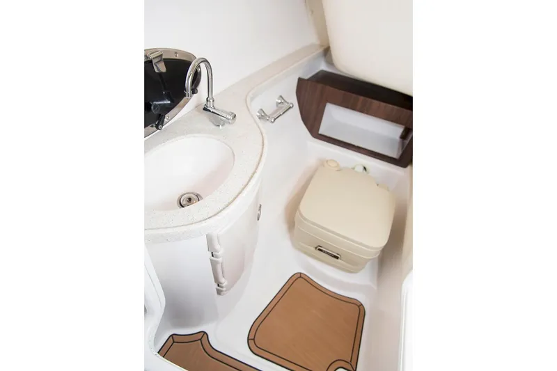 Slide: The Image of Manufacturer Provided Image: 2017 Regal 2700 ES Bowrider boat bathroom with sink and portable toilet. - 23