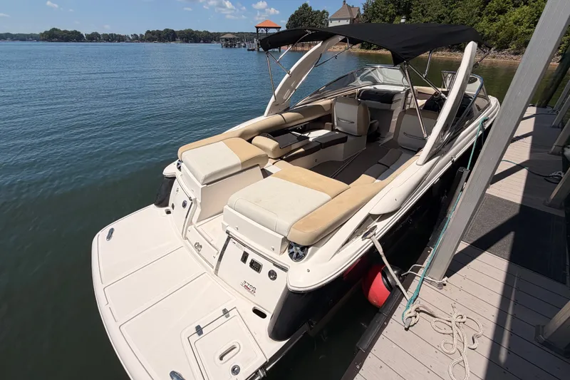 Slide: The Image of 2017 Regal 2700 ES Bowrider docked on a sunny lake with canopy. - 2