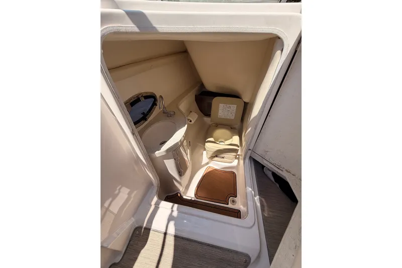 Slide: The Image of 2017 Regal 2700 ES Bowrider interior with compact bathroom and sink. - 12