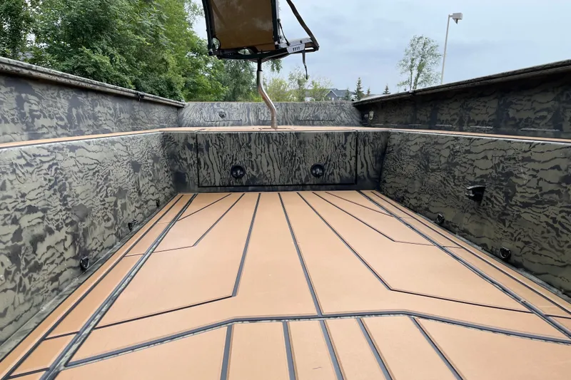 Slide: The Image of 2026 Tracker Grizzly 1650 T Prairie Wings Edition boat interior with camouflage design and spacious deck. - 27