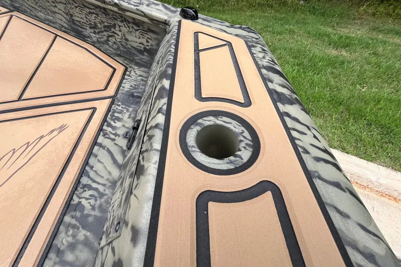 Slide: The Image of 2026 Tracker Grizzly 1650 T Prairie Wings Edition boat with camouflage design and deck details. - 22